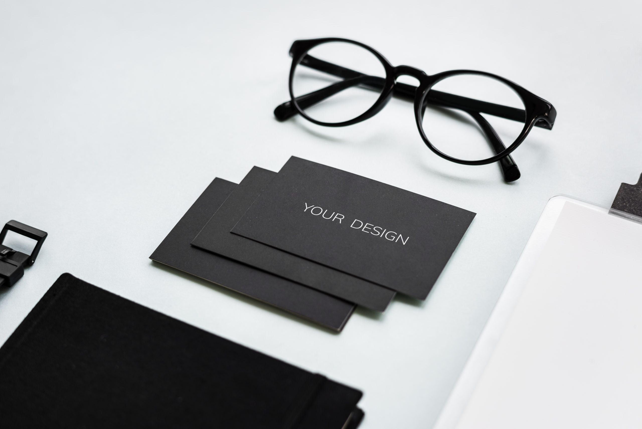 closeup-of-black-paper-cards-with-eyeglasses-on-ta-2023-11-27-05-13-40-utc-scaled